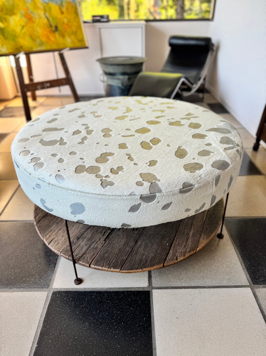 Bespoke metallic cowhide ottoman with magazine rack on recycled timbers